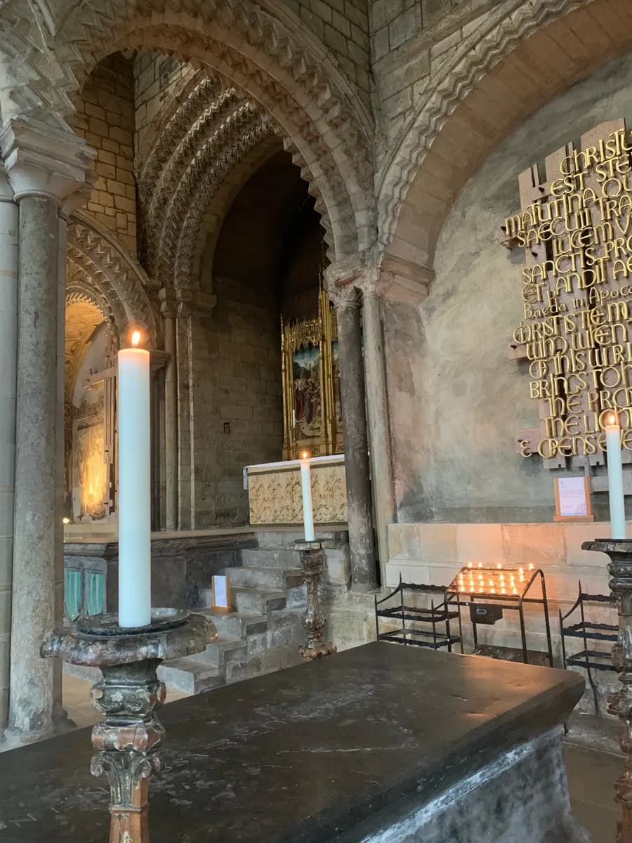 Candlelit altar beneath carved stone arches in the Galilee Chapel of Durham Cathedral